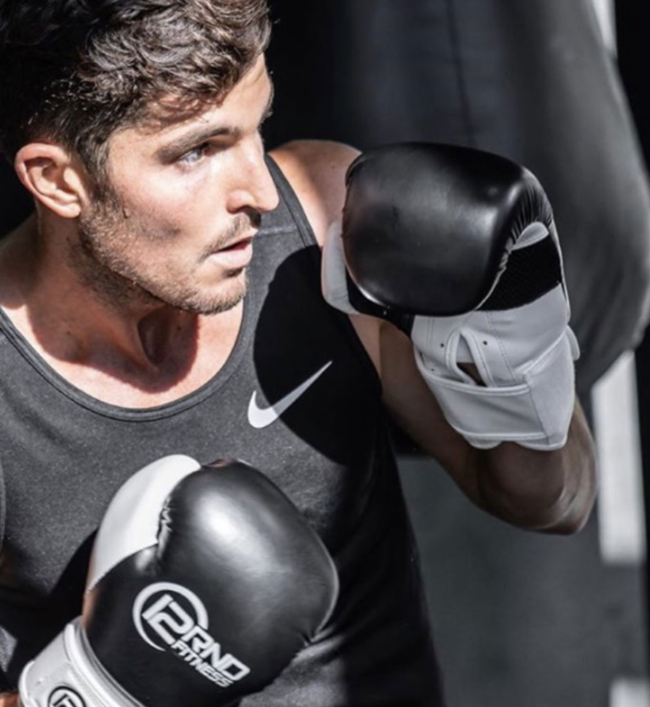 Boxer in black boxing gloves